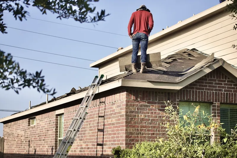 Professional roofer working on a residential roof in East Aurora